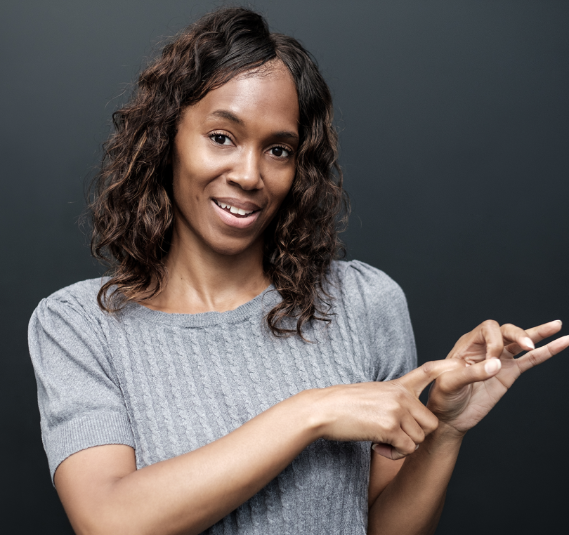 mature-deaf-woman-using-sign-language-on-black-bac-2024-07-10-04-19-56-utc copy