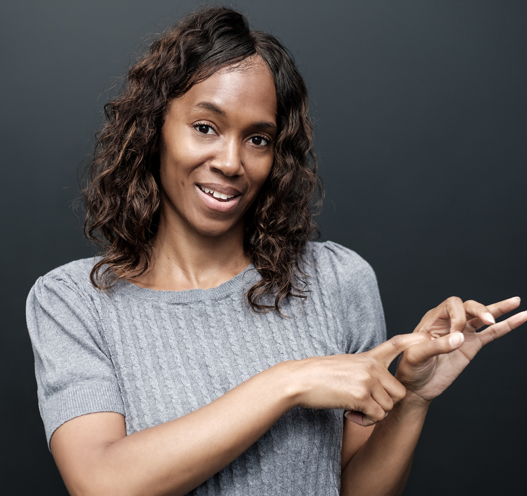 mature-deaf-woman-using-sign-language-on-black-bac-2024-07-10-04-19-56-utc copy